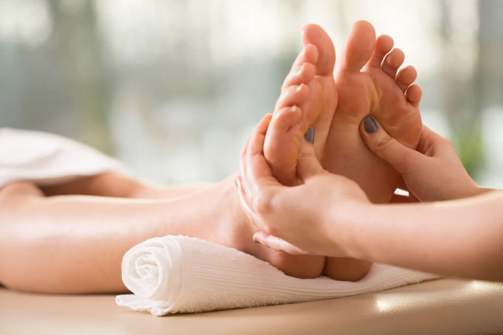 Person receiving a foot massage with both feet