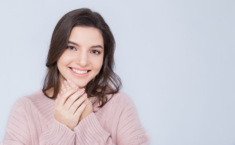 Smiling young woman after dermaplaning