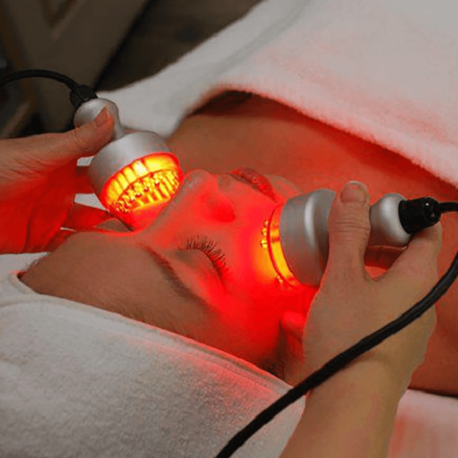 Red light laser therapy on a woman's cheeks