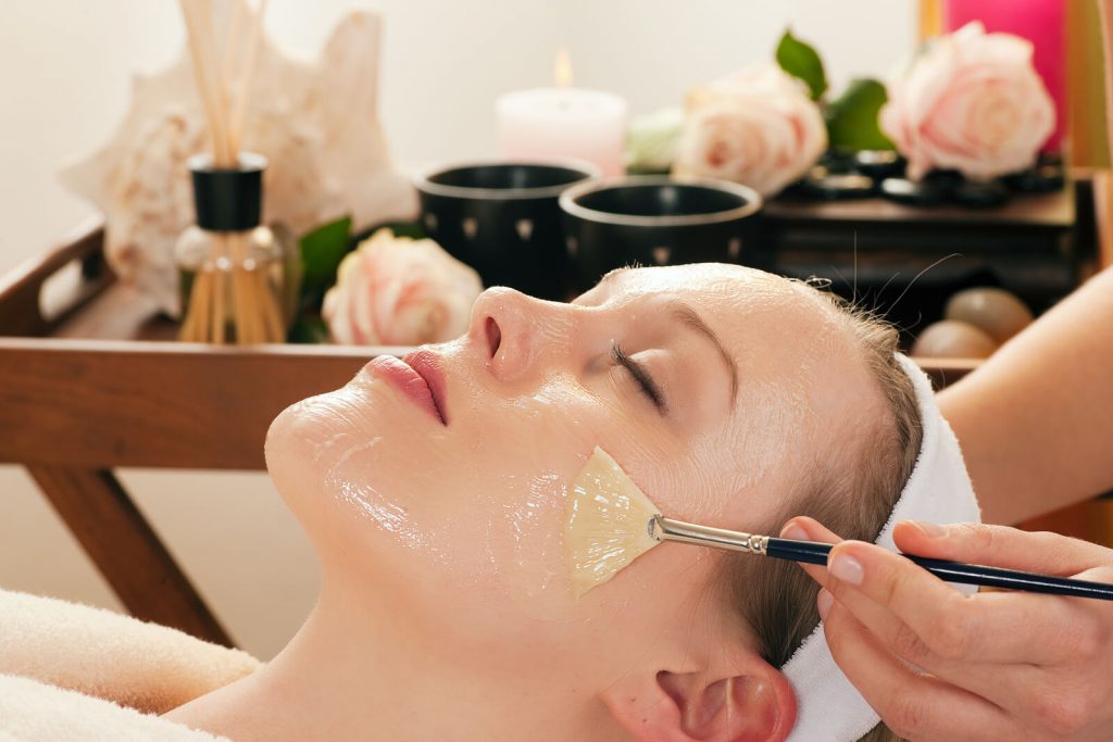 woman getting skin care facial mask