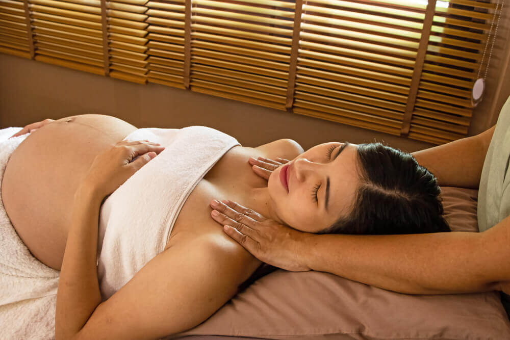 Pregnant women enjoys prenatal massage at spa